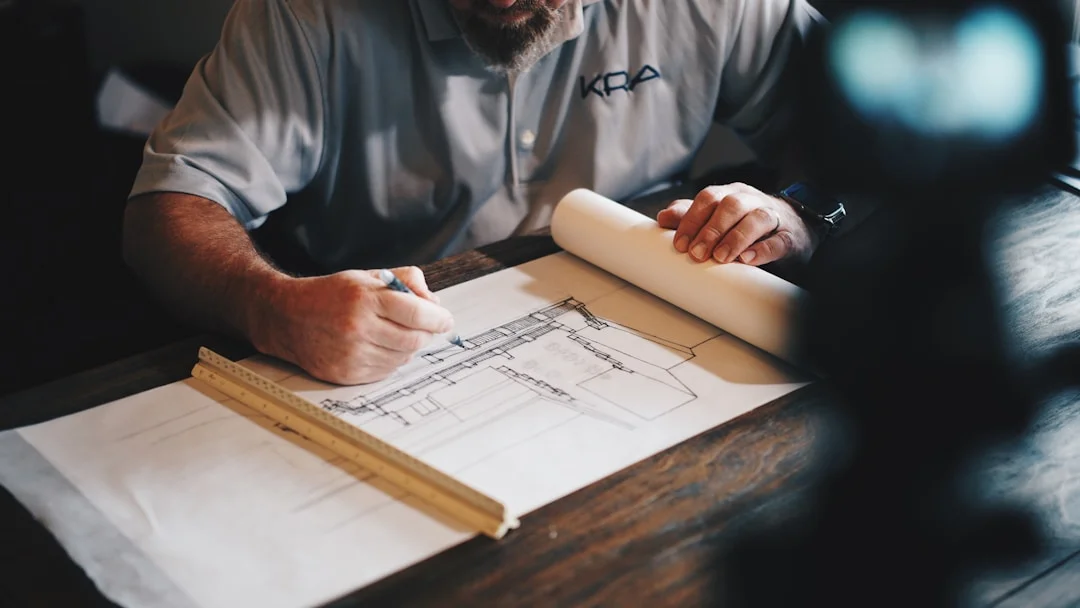 Contractor examining architectural blueprints at a work table