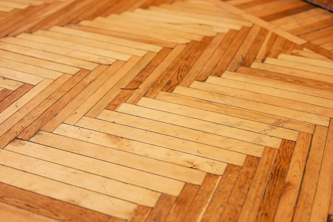 Hardwood parquet floor in herringbone pattern, typical of heritage-era homes