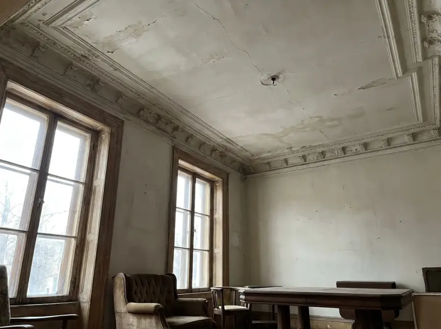 Plaster ceiling with crown molding, cracks and a water infiltration stain