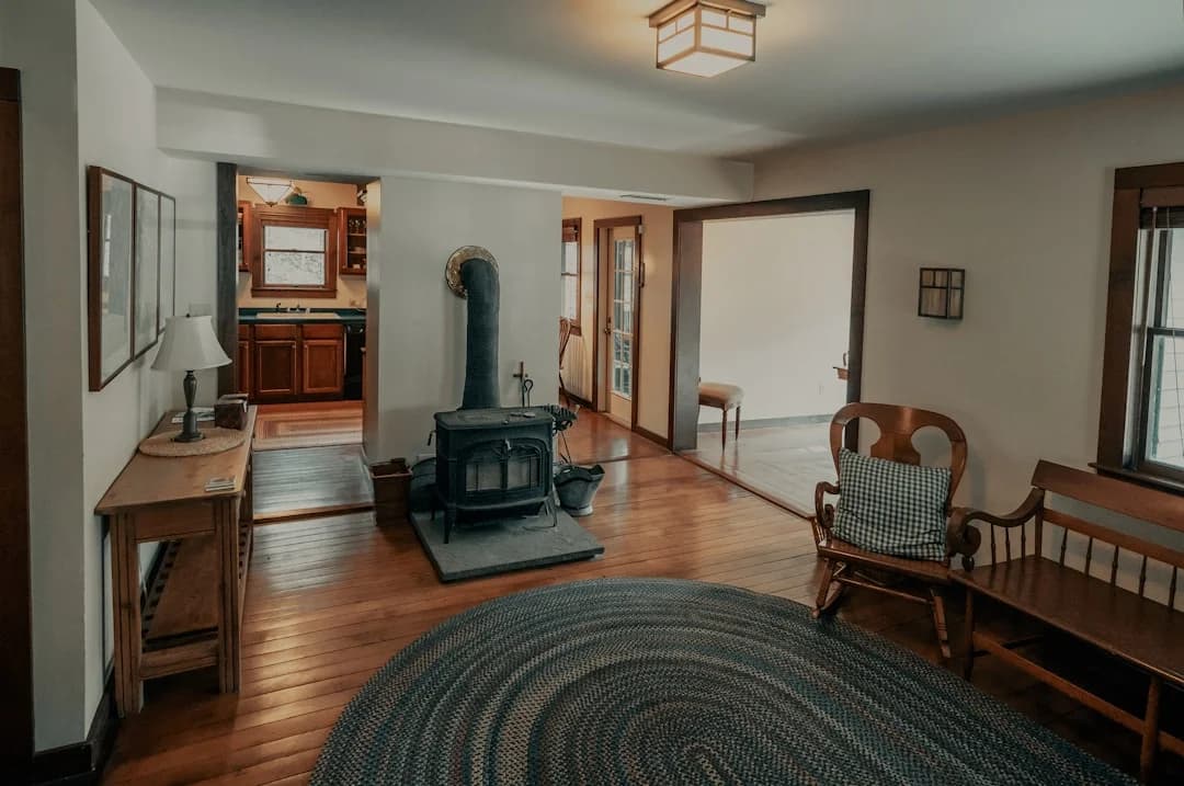 Warm interior of an old country home with wood stove and original hardwood floors